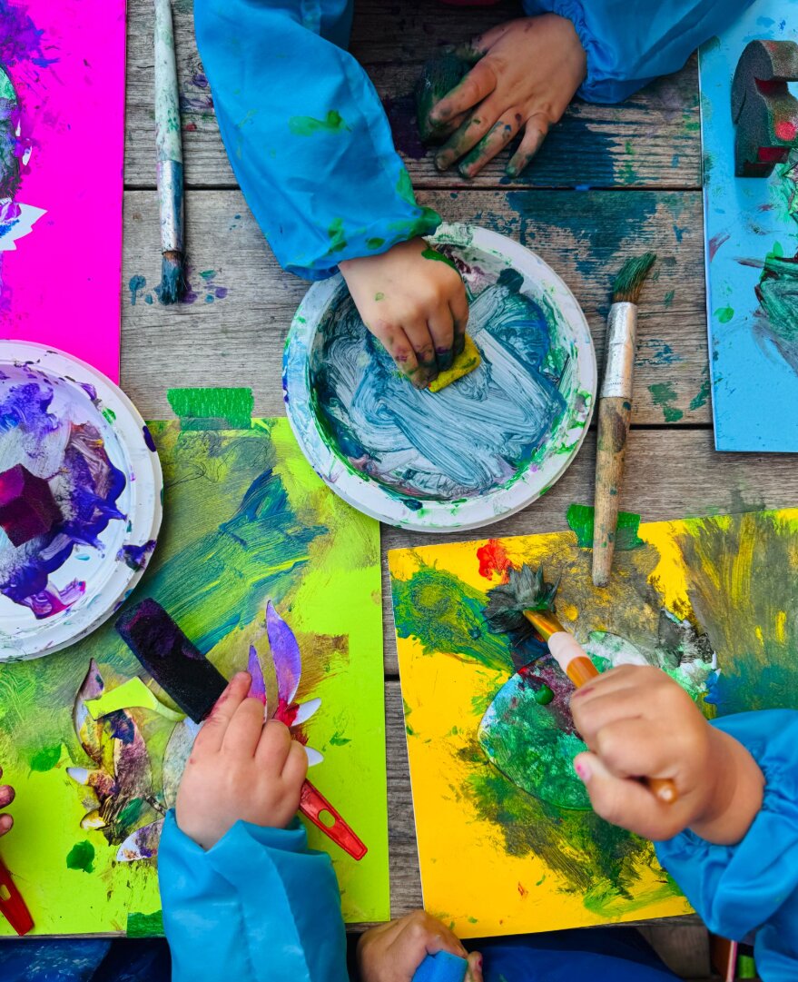 Children painting on stencils with different tools