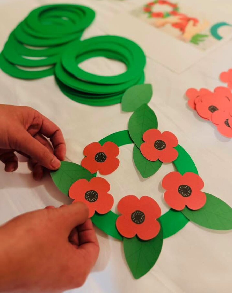 Children creating poppy wreaths for Remembrance Day