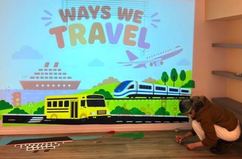 Detail of the transportation mural showing a school bus and train
