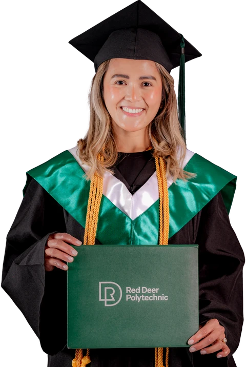 Jowena Lagumbay in cap and gown holding her Red Deer Polytechnic diploma